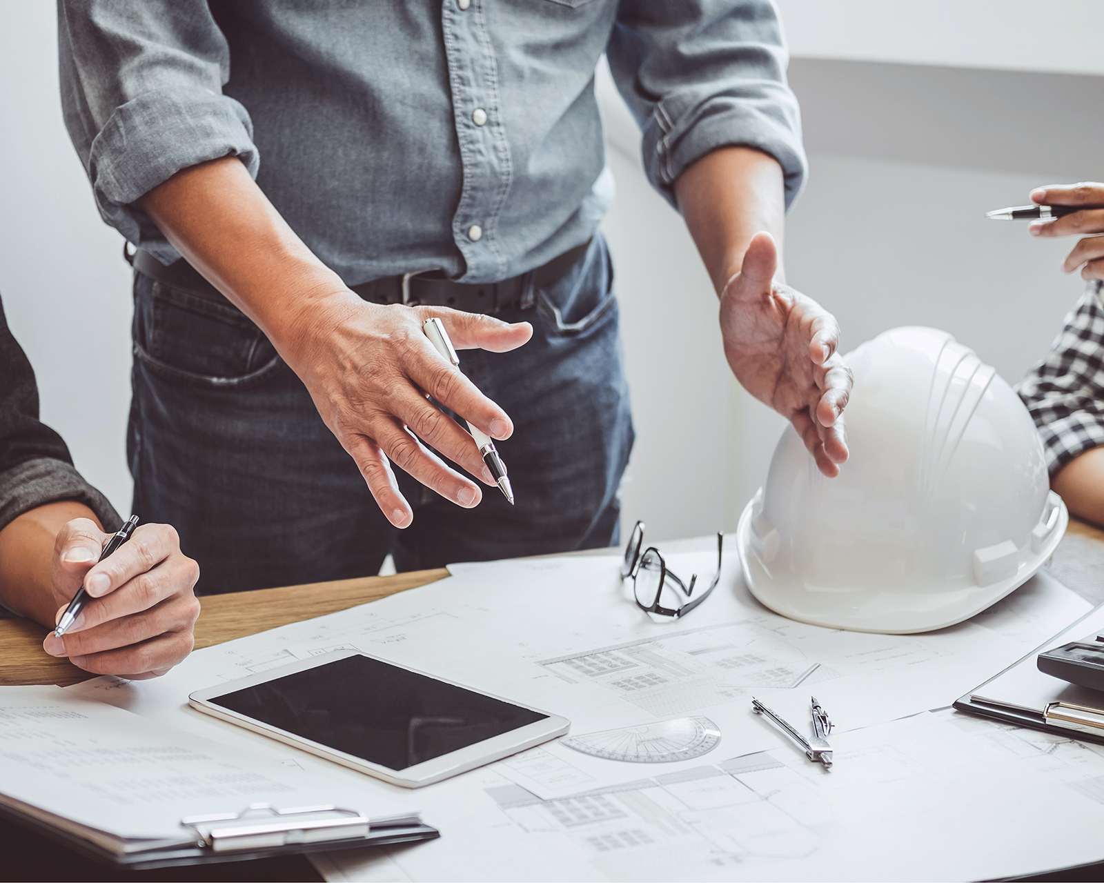 Construction and structure concept of Engineer or architect meeting for project working with partner and engineering tools on model building and blueprint in working site, contract for both companies.